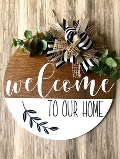 a wooden sign that says welcome to our home