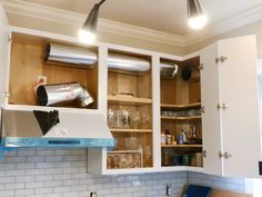 a kitchen with white cupboards and blue counter tops is seen in this image from the front view