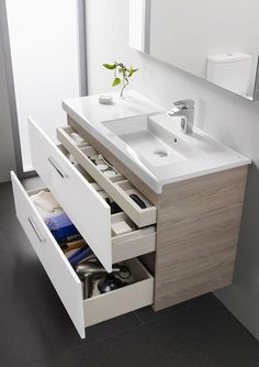 a bathroom vanity with drawers and a sink