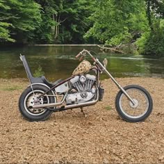 a motorcycle parked on the side of a river