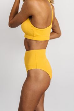 Vibrant yellow hue Ribbed swimsuit material High waisted style Banded waist design Moderate to cheeky coverage Fully lined Body: 90% Nylon, 10% Spandex Lining: 100% Polyester Trina is 5'6, cup size 32D, size 2 and is wearing size S Yellow Lined Swimwear For Vacation, High Waist Seamless Swimwear, Yellow Fitted High-waist Swimwear, Yellow Seamless Swimwear For Beach Season, Yellow High Waist Stretch Swimwear, High Waist Yellow Bottoms For Poolside, Yellow Beachwear Swimwear With Lined Body, High Waist Yellow Swimwear For Beach, Yellow Seamless Swimwear For Poolside