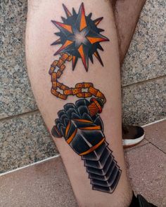 a man's leg with tattoos on it and an image of a hand holding a chain