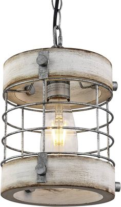 an old fashioned light fixture hanging from the ceiling with metal caged wire around it