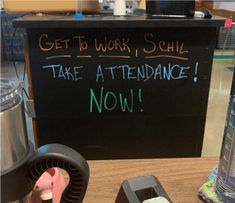 a sign that says get to work, schl take a attendance now on the table