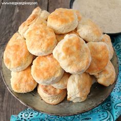 a plate full of biscuits next to some dipping sauce