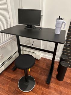 a computer desk with a monitor and keyboard on it