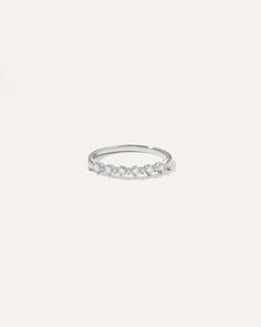 a white gold ring with five diamonds