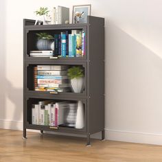 a book shelf with books on top of it next to a white wall and wooden floor