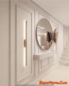 a white room with a round mirror on the wall next to some stairs and plants