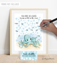 a person is drawing an octopus with watercolors on the wall next to a sign that says you are so loved