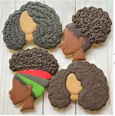 four decorated cookies with black women's hair on top of each cookie, one is brown and the other is green