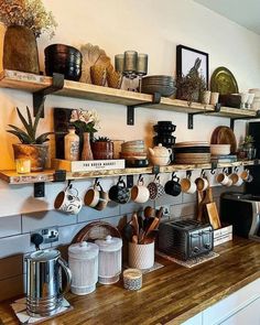 the shelves are filled with pots, pans and other kitchen utensil items