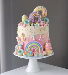 there is a cake that looks like it has been decorated with rainbows and unicorns