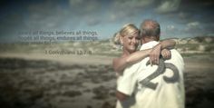 a man and woman embracing each other on the beach