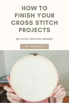 a person holding up a white circular object with the words how to finish your cross stitch projects