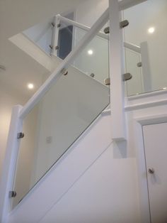 a stair case with glass railings in a home