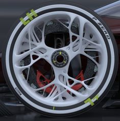 the front wheel of a red sports car with white spokes and yellow tape around it