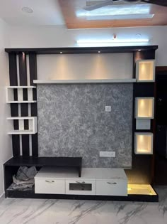 a living room with black and white walls and shelves on the wall, along with marble flooring