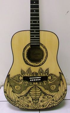 a wooden guitar with an intricate design on it