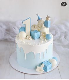 a blue and white cake with teddy bears on top