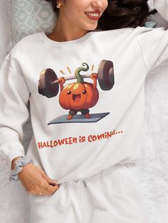 Get ready to lift your Halloween spirit with this fun and cozy unisex crewneck sweatshirt! Featuring a cute, powerlifting pumpkin and the phrase "Halloween is Coming," this sweatshirt is the perfect blend of festive and fitness. Ideal for pumpkin lovers, gym enthusiasts, or anyone who wants to celebrate Halloween in style. Soft, comfortable, and perfect for fall weather--this sweater will be your go-to for spooky season fun! Ideal for any situation, a unisex heavy blend crewneck sweatshirt is pure comfort. These garments are made from polyester and cotton. This combination helps designs come out looking fresh and beautiful. The collar is ribbed knit, so it retains its shape even after washing. There are no itchy side seams on these sweaters.  .: Made with a medium-heavy fabric blend of 50% White Sweatshirt For Gym, Fall Season, Fall Gym White Sweatshirt, White Sweatshirt For Gym In Fall, White Gym Sweatshirt For Fall, Fall Gym Sweatshirt With Graphic Print, Graphic Print Sweatshirt For Fall, Graphic Print Sweatshirt For Gym Use In Fall, Graphic Print Gym Top For Fall, Halloween Is Coming