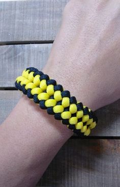 a person wearing a yellow and black bracelet