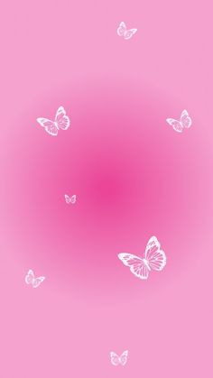 a pink background with white butterflies flying in the air