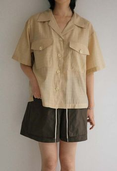 One size. fits xs-l  color: sand  boxy button down  two front pockets  lightweight  45% rayon 40% tencel 15% polyester  dry clean  by the nkc store    product measurements:  bust: 106.68cm / 42in  length: 55.88cm / 22in  sleeve length: 22.86cm / 9in Beige Camp Collar Shirt With Buttons, Beige Shirt With Buttons And Camp Collar, Cream Button-up Shirt With Pockets, Beige Collared Shirt With Buttoned Pockets, Beige Shirt With Buttoned Pockets, Cream Button-up Top With Pockets, Summer Beige Top With Lapel Collar, Beige Tops With Buttoned Pockets For Everyday, Everyday Beige Tops With Buttoned Pockets