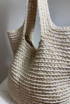 a large white bag sitting on top of a counter next to a wall and floor