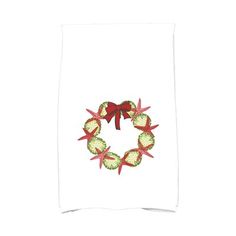 a white towel with a red bow and green fruit wreath on the front of it