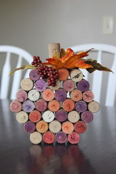 a wine cork pumpkin sitting on top of a wooden table