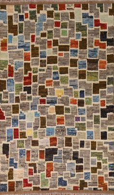 a multicolored rug with squares and rectangles