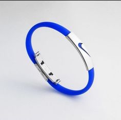 Nike Unisex/Men's Sport Silicone Rubber Wristbands Bracelet, Blue Adjustable Silicone Band & Silver Stainless Steel Clasp. Comes With Metal Container,Brand New. Adjustable Blue Band Bracelets, Rubber Wristbands, Air Force One Shoes, Necklace Gift Box, Handmade Leather Bracelets, Sport Accessories, Nike Gold, Rubber Bracelets, Metal Containers