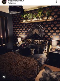 a leopard print bed spread and pillows in a bedroom with black walls, dark wood headboard