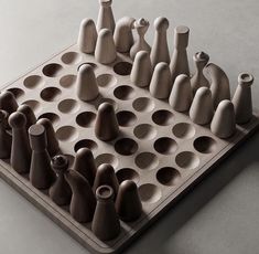 a chess board made out of clay with several pieces on it and one piece in the middle