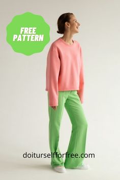 a woman in pink sweater and green pants