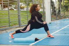 a woman is doing exercises on a blue mat