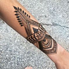 a person's arm with a tattoo on it and an arrow in the middle