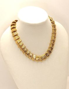 Vintage 80's Gold Tone Chunky Speciality Link Necklace A vibrant gold tone textured articulated speciality link.  The gold tone is rich and in perfect condition. A solid heavy chain that bespeaks quality.  Vintage throwback to 40's Retro. Toggle Clasp  Length: 18 inches Width: 3/4 inch This is a pre-owned vintage item, it has been cleaned, inspected and found to be in excellent vintage condition with minimal signs of wear. Comes in a gift box ideal for gift giving and storage. Item # GT0017 Vintage Gold Metal Toggle Necklace, Vintage Gold Toggle Chain Necklace, Vintage Gold Toggle Necklace With Chunky Chain, Gold Vintage Toggle Necklace With Chunky Chain, Vintage Gold Toggle Necklace, Formal Gold-tone Metal Toggle Necklace, Heavy Chain, Toggle Clasp, Link Necklace