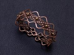 Handmade serpentine wire wrapped copper and 4 mm tiny bronze beads women weaved bracelet . Perfect gift for girlfriend , unique and special gift for wife for 7th copper wedding anniversary . Bracelet width : 2 cm - 0.8" Copper is oxidized to give it an antique appearance. Please read about copper care on Info & Faq section. The requested piece it's made to order similar with the original shown item . Please be sure to read the entire description of the item before you purchase. Item images may s Anniversary Bracelet, Leo Birthstone, Copper Wedding Anniversary, Statement Cuff Bracelet, Perfect Gift For Girlfriend, Copper Wedding, Tigers Eye Gemstone, Amethyst Purple, Bracelets Handmade Beaded