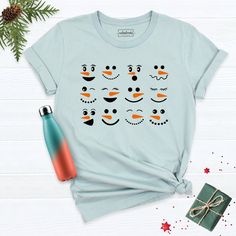 Christmas Snowman Shirt, Snowman T-Shirt, Matching Family Shirt, Christmas Family Tee, Winter Time Shirt, Winter Snowman Shirt, Xmas Shirt. Hi! Welcome to our store. It's good to see you here. Our aim is to offer you first-class clothing in your most beautiful moments with our graphic t-shirts that we designed or designed with your ideas. I am sure you will like our designs for your family, friends and you. IMPORTANT MATTERS FOR ORDERING: 1-) Please check and review all photos. 2-) Our sizes are true to size, but can you take a look at my measurements in the product details section to make sure you get the best fit? The measurement is from armpit to armpit. Please let me know if you have any questions. BUSINESS DAYS: Normally postal time is 2-6 working days, rush mail is 1-4 working days, Fun Winter T-shirt With Crew Neck, Fun Winter Crew Neck T-shirt, Fun Crew Neck T-shirt For Winter, Fun Christmas Crew Neck T-shirt, Fun Short Sleeve Winter Tops, Snowmen Faces, Cute Snowmen, Matching Family Shirt, Snowman Shirt