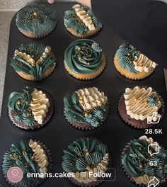 twelve cupcakes with green frosting and gold sprinkles in a muffin tin