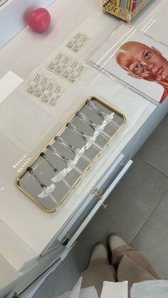 a table that has some items on it and someone standing in front of the table