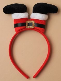 a red and black headband with santa claus's hat on it, which is attached to a brown wall