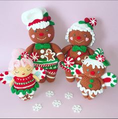 three crocheted gingerbread man and woman dolls with snowflakes on them