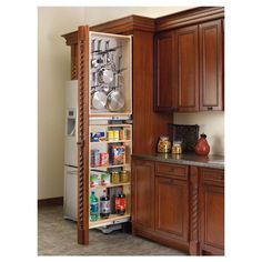 an open refrigerator in a kitchen next to wooden cabinets