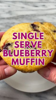 a person holding up a blueberry muffin with the words single serve on it