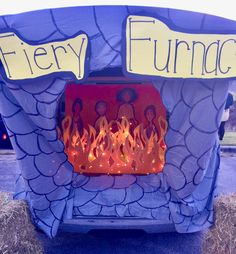 there is a blue fire pit with flames in it