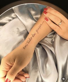 a woman's arm with the words love and happiness tattooed on her left wrist