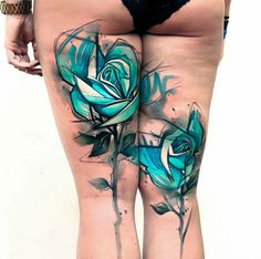 a woman's legs with blue flowers painted on the thigh and one leg is shown